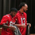 Arizona Cardinals WRs Antoine Wesley and Greg Dortch pass out backpacks during a charity event at Adams Elementary on Monday, Sept. 12, 2022, in Mesa. (Tyler Drake/Arizona Sports)
