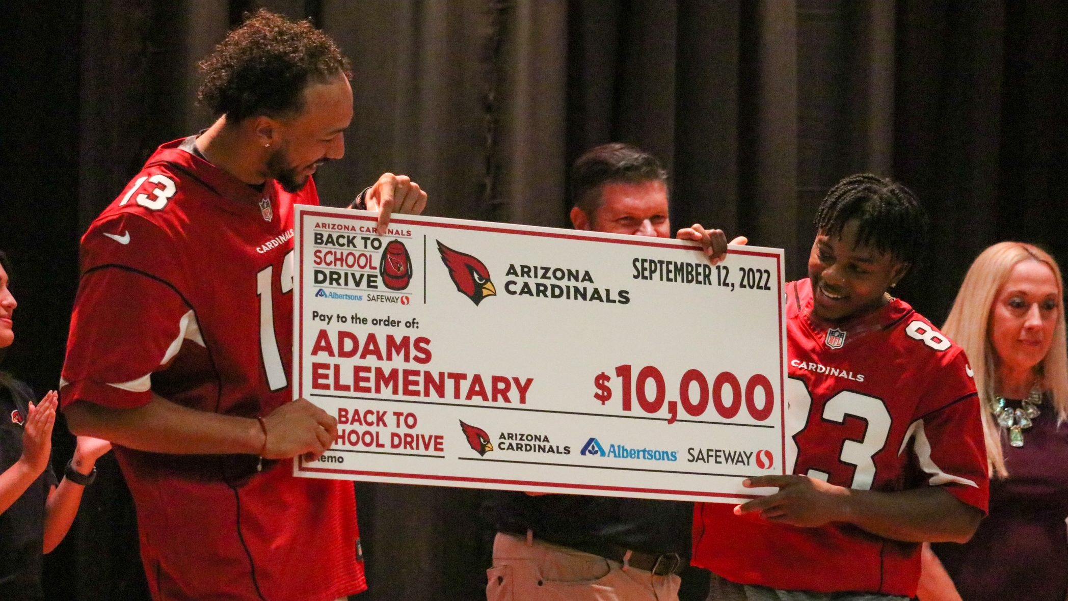 Arizona Cardinals WRs Antoine Wesley and Greg Dortch present a check for $10,000 to Adams Elementar...