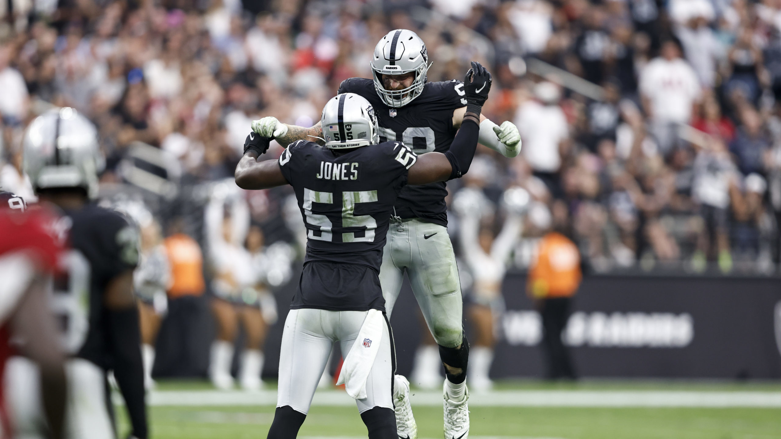 Maxx Crosby #98 of the Las Vegas Raiders celebrates with his teammate Chandler Jones #55 after maki...