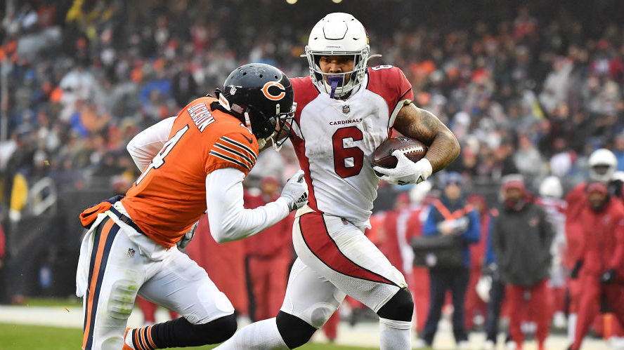 James Conner #6 of the Arizona Cardinals runs with the ball against Eddie Jackson #4 of the Chicago...