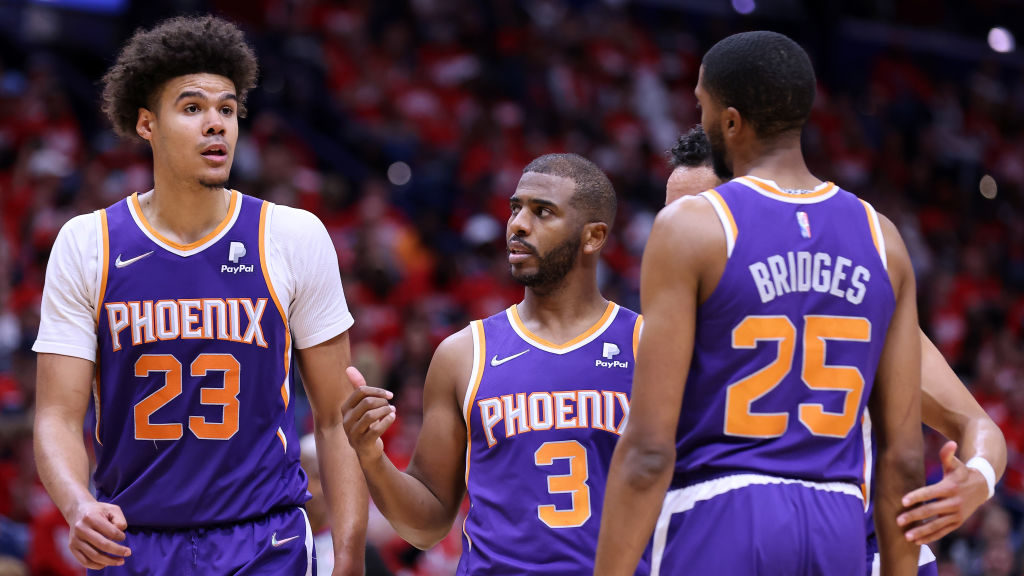 Chris Paul #3, Cameron Johnson #23 an Mikal Bridges #25 of the Phoenix Suns react during Game Four ...