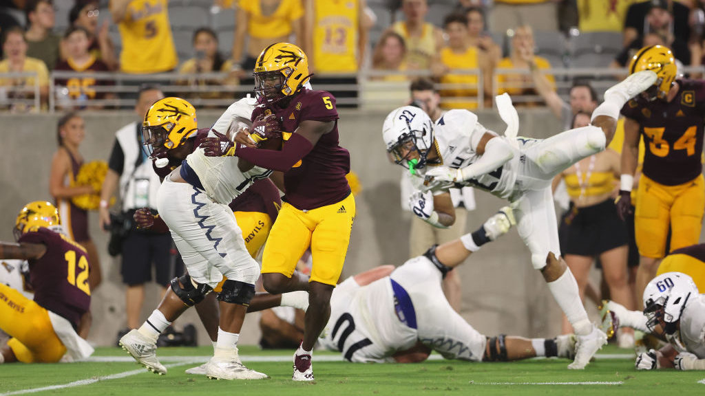 Defensive back Chris Edmonds #5 of the Arizona State Sun Devils runs with the football after an int...