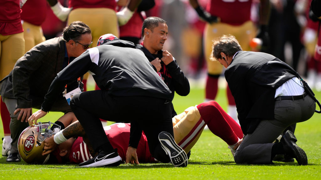 Trey Lance #5 of the San Francisco 49ers is tended to after an apparent injury following a play aga...