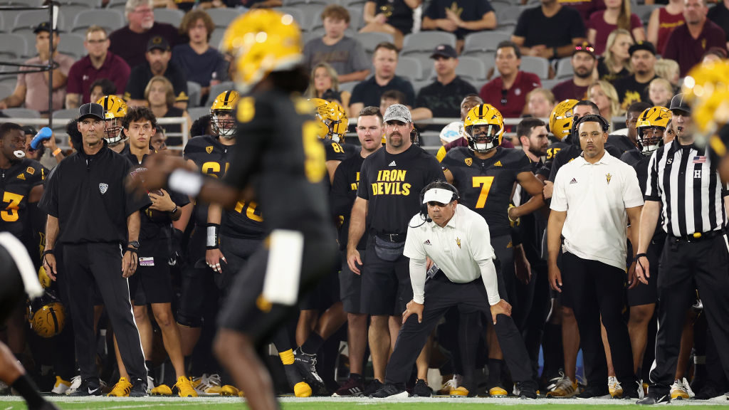 Interim head coach Shaun Aguano of the Arizona State Sun Devils watches from the sidelines during t...