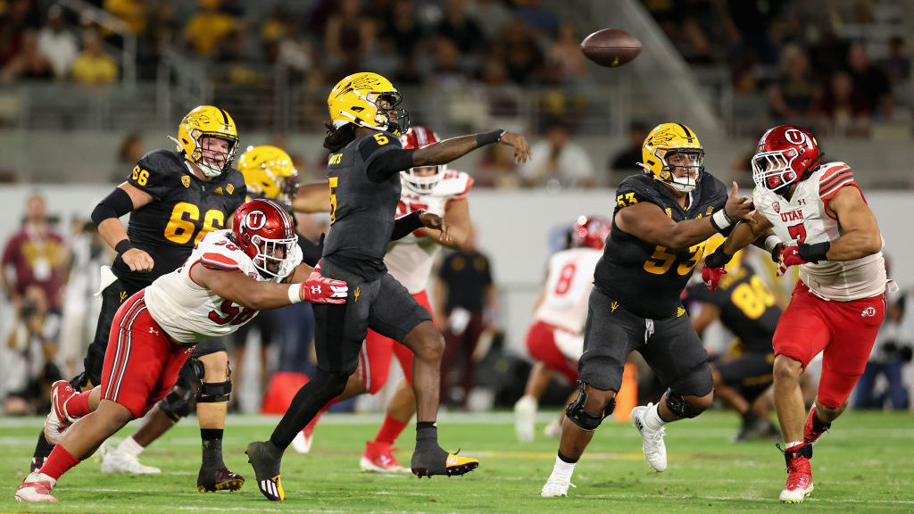 Quarterback Emory Jones #5 of the Arizona State Sun Devils throws a pass under pressure from defens...