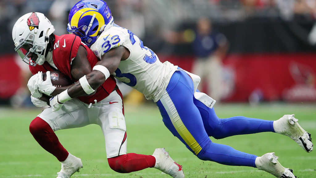 Safety Nick Scott #33 of the Los Angeles Rams tackles wide receiver Marquise Brown #2 of the Arizon...