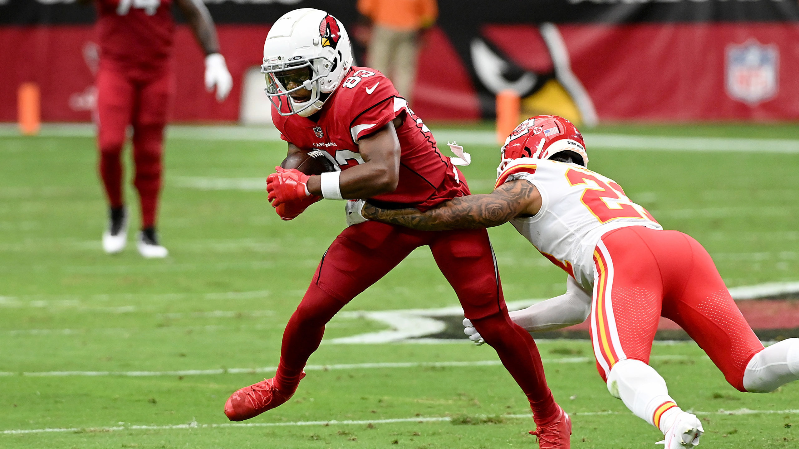 Wide receiver Greg Dortch #83 of the Arizona Cardinals tries to avoid the tackle of cornerback Tren...