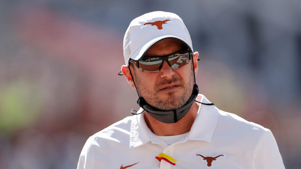 Head coach Tom Herman of the Texas Longhorns watches players warm up before the game against the We...