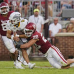 Oklahoma linebacker Danny Stutsman (28) brings down Kent State quarterback Collin Schlee (19) during the first half of an NCAA college football game Saturday, Sept. 10, 2022, in Norman, Okla. (AP Photo/Sue Ogrocki)