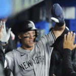 
              New York Yankees' Aaron Judge is congratulated after scoring a run against the Toronto Blue Jays during the third inning of a baseball game Tuesday, Sept. 27, 2022, in Toronto. (Nathan Denette/The Canadian Press via AP)
            