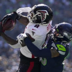 Atlanta Falcons tight end Kyle Pitts hauls in a pass as Seattle Seahawks safety Josh Jones defends during the first half of an NFL football game Sunday, Sept. 25, 2022, in Seattle. (AP Photo/Ashley Landis)
