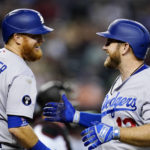 Los Angeles Dodgers' Max Muncy, right, smiles as he celebrates his home run against the Arizona Diamondbacks with Justin Turner (10) during the seventh inning of a baseball game in Phoenix, Tuesday, Sept. 13, 2022. (AP Photo/Ross D. Franklin)