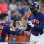 
              Houston Astros designated hitter Yordan Alvarez, right, is congratulated by Jose Altuve after hitting a solo home run during the eighth inning of a baseball game against the Los Angeles Angels, Sunday, Sept. 11, 2022, in Houston. (AP Photo/Kevin M. Cox)
            
