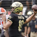 
              Wake Forest quarterback Sam Hartman (10) looks to pass against Clemson during the first half of an NCAA college football game in Winston-Salem, N.C., Saturday, Sept. 24, 2022. (AP Photo/Chuck Burton)
            