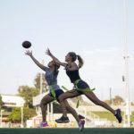 
              Syndel Murillo, 16, left, and Shale Harris, 15, reach for a pass as they try out for the Redondo Union High School girls flag football team on Thursday, Sept. 1, 2022, in Redondo Beach, Calif. Southern California high school sports officials will meet on Thursday, Sept. 29, to consider making girls flag football an official high school sport. This comes amid growth in the sport at the collegiate level and a push by the NFL to increase interest. (AP Photo/Ashley Landis)
            