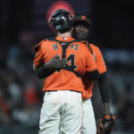 San Francisco Giants relief pitcher Yunior Marte, rear, hugs catcher Austin Wynns after the team's 10-4 victory over the Arizona Diamondbacks in a baseball game in San Francisco, Friday, Sept. 30, 2022. (AP Photo/Godofredo A. Vásquez)