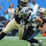 
              Carolina Panthers running back Christian McCaffrey (22) carries the ball against New Orleans Saints linebacker Pete Werner (20) and defensive end Cameron Jordan (94) during the first half of an NFL football game, Sunday, Sept. 25, 2022, in Charlotte, N.C. (AP Photo/Rusty Jones)
            