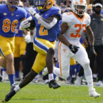 
              Pittsburgh running back Israel Abanikanda, right, runs past Tennessee linebacker Jeremy Banks (33) on his way to a touchdown during the first half of an NCAA college football game, Saturday, Sept. 10, 2022, in Pittsburgh. (AP Photo/Keith Srakocic)
            