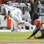 New York Jets tight end Tyler Conklin, left, is tackled by Cleveland Browns cornerback Martin Emerson Jr., right, after making a catch during the second half of an NFL football game, Sunday, Sept. 18, 2022, in Cleveland. (AP Photo/Ron Schwane)
