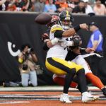 
              Pittsburgh Steelers quarterback Mitch Trubisky (10), front, is pressured by Cincinnati Bengals defensive end Sam Hubbard, back,as he throws during the second half of an NFL football game, Sunday, Sept. 11, 2022, in Cincinnati. (AP Photo/Jeff Dean)
            