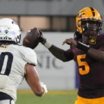 Arizona State quarterback Emory Jones (5) looks to pass while being pressured by Northern Arizona defensive lineman Mark Ho Ching during the second half of an NCAA college football game Thursday, Sept. 1, 2022, in Tempe, Ariz. (AP Photo/Rick Scuteri)