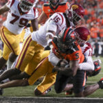 
              Oregon State running back Deshaun Fenwick scores a touchdown as Southern California linebacker Eric Gentry (18) and defensive back Anthony Beavers Jr. (15) try to bring him down during the first half of an NCAA college football game Saturday, Sept. 24, 2022, in Corvallis, Ore. (AP Photo/Amanda Loman)
            