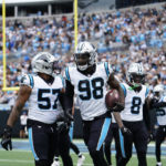 Carolina Panthers defensive end Marquis Haynes Sr. (98) runs off the field after he recovers a fumble and runs in for a touchdown during the first half of an NFL football game against the New Orleans Saints, Sunday, Sept. 25, 2022, in Charlotte, N.C. (AP Photo/Jacob Kupferman)