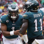 Philadelphia Eagles wide receiver A.J. Brown (11) and quarterback Jalen Hurts (1) celebrating their touchdown against the Washington Commanders during the first half of an NFL football game, Sunday, Sept. 25, 2022, in Landover, Md. (AP Photo/Alex Brandon)