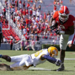 Georgia running back Kendall Milton (2) gets past Kent State defensive back Naijee Jones (26) in the second half of an NCAA college football game Saturday, Sept. 24, 2022, in Athens, Ga. (AP Photo/John Bazemore)