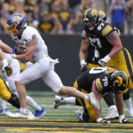 
              South Dakota State linebacker Caleb Francl, left, runs from Iowa offensive lineman Beau Stephens (70) after intercepting a pass during the first half of an NCAA college football game, Saturday, Sept. 3, 2022, in Iowa City, Iowa. (AP Photo/Charlie Neibergall)
            