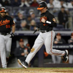 Baltimore Orioles' Adley Rutschman scores on a wild pitch by New York Yankees' Zack Britton during the sixth inning of a baseball game Friday, Sept. 30, 2022, in New York. (AP Photo/Adam Hunger)