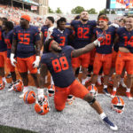 
              Illinois defensive lineman Keith Randolph Jr., leads his teammates in singing the school's alma mater after an NCAA college football game against Virginia, Saturday, Sept. 10, 2022, in Champaign, Ill. Illinois won 24-3. (AP Photo/Charles Rex Arbogast)
            