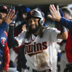 
              Minnesota Twins' Billy Hamilton is congratulated in the dugout after he scored against the Chicago White Sox during the eighth inning of a baseball game Wednesday, Sept. 28, 2022, in Minneapolis. The Twins won 8-4. (AP Photo/Craig Lassig)
            