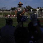 
              Jake Jimenez, Redondo Union High School girl's flag football coach, talks to girls trying out for a flag football team on Thursday, Sept. 1, 2022, in Redondo Beach, Calif. Southern California high school sports officials will meet on Thursday, Sept. 29, to consider making girls flag football an official high school sport. This comes amid growth in the sport at the collegiate level and a push by the NFL to increase interest. (AP Photo/Ashley Landis)
            
