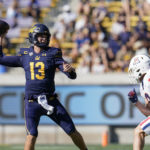 California quarterback Jack Plummer (13) throws a pass while being pressured by Arizona safety Gunner Maldonado (9) during the first half of an NCAA college football game in Berkeley, Calif., Saturday, Sept. 24, 2022. (AP Photo/Godofredo A. Vásquez)