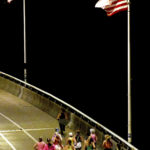 
              A group of runners cross the Veteran's Bridge as they return to Girls Preparatory School as they take part in  "Finish Eliza's Run" on Friday, Sept. 9, 2022 in Chattanooga, Tenn. The approximately four mile run was to memorialize, Eliza Fletcher, the Memphis runner, and mother of two, who was murdered during her early morning run.   (Robin Rudd /Chattanooga Times Free Press via AP)
            