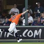 Houston Astros center fielder Chas McCormick reaches for a RBI triple by Tampa Bay Rays' Randy Arozarena during the fifth inning of a baseball game Friday, Sept. 30, 2022, in Houston. (AP Photo/David J. Phillip)
