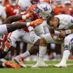 
              Clemson Tigers defensive tackle Ruke Orhorhoro pulls off the helmet of Furman Paladins quarterback Tyler Huff (6) in the first quarter during an NCAA college football game in Clemson, S.C., Saturday, Sept. 10, 2022. (AP Photo/Jacob Kupferman)
            