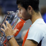 
              Carlos Alcaraz, of Spain, kisses the championship trophy after defeating Casper Ruud, of Norway, in the men's singles final of the U.S. Open tennis championships, Sunday, Sept. 11, 2022, in New York. (AP Photo/John Minchillo)
            
