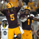 Arizona State running back Xazavian Valladay (1) celebrates with quarterback Emory Jones (5) after scoring a touchdown against Northern Arizona during the second half of an NCAA college football game Thursday, Sept. 1, 2022, in Tempe, Ariz. (AP Photo/Rick Scuteri)