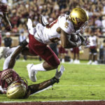 
              Boston College running back Alex Broome (20) dives over Florida State linebacker DJ Lundy (46) to score a touchdown during the third quarter of an NCAA college football game on Saturday, Sept. 24, 2022, in Tallahassee, Fla. (AP Photo/Gary McCullough)
            
