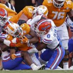 Tennessee running back Jabari Small (2) is stopped at the goal line by Florida safety Trey Dean III (0) and others during the first half of an NCAA college football game Saturday, Sept. 24, 2022, in Knoxville, Tenn. (AP Photo/Wade Payne)