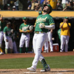 
              Oakland Athletics' Seth Brown, right, looks up as he crosses home plate after hitting a solo home run against the New York Mets during the third inning of a baseball game in Oakland, Calif., Saturday, Sept. 24, 2022. (AP Photo/Tony Avelar)
            