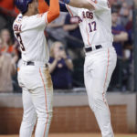Houston Astros' Jeremy Pena (3) and David Hensley (17) celebrate after they both scored on the two run home run by Hensley during the sixth inning of a baseball game against the Arizona DiamondbacksTuesday, Sept. 27, 2022, in Houston. (AP Photo/Michael Wyke)