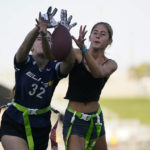
              Aly Young, 17, left, and Shale Harris, 15, reach to catch a pass as they try out for the Redondo Union High School girls flag football team on Thursday, Sept. 1, 2022, in Redondo Beach, Calif. Southern California high school sports officials will meet on Thursday, Sept. 29, to consider making girls flag football an official high school sport. This comes amid growth in the sport at the collegiate level and a push by the NFL to increase interest. (AP Photo/Ashley Landis)
            