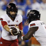 Northern Illinois quarterback Ethan Hampton (2) hands the ball off to Northern Illinois running back Antario Brown (1) during the first half of an NCAA college football game against Kentucky in Lexington, Ky., Saturday, Sept. 24, 2022. (AP Photo/Michael Clubb)