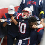 
              New England Patriots quarterback Mac Jones (10) is helped off the field after suffering a leg injury with less than two minutes to play in the second half of an NFL football game against the Baltimore Ravens, Sunday, Sept. 25, 2022, in Foxborough, Mass. (AP Photo/Michael Dwyer)
            