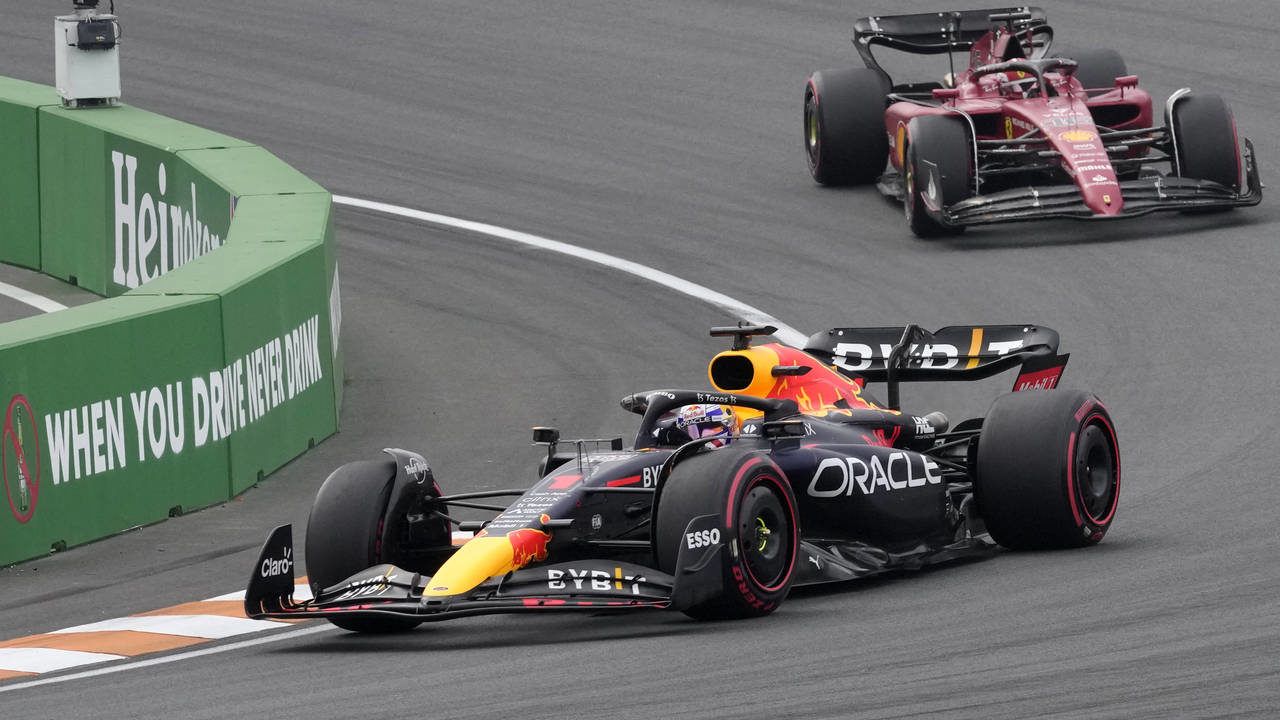 Red Bull driver Max Verstappen of the Netherlands leads Ferrari driver Charles Leclerc of Monaco, r...