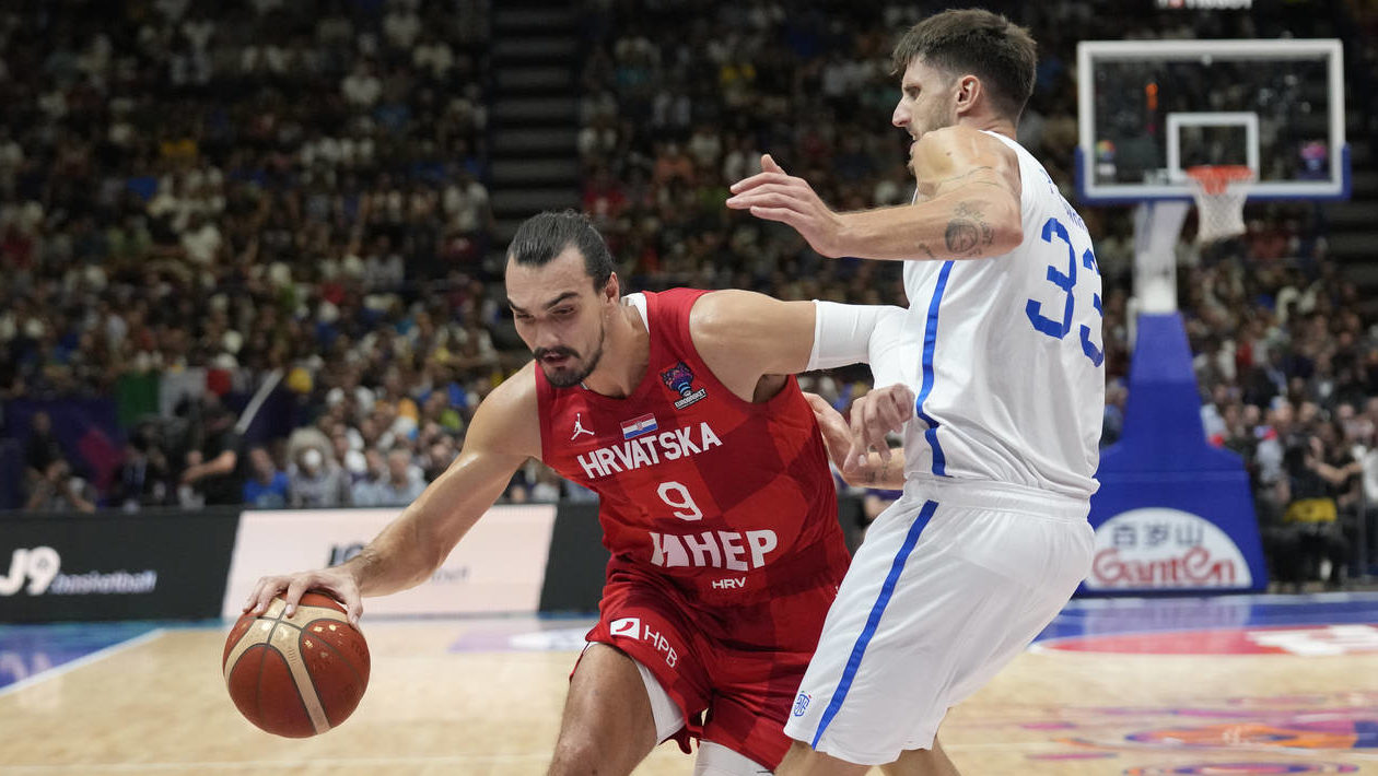 Croatia's Dario Saric, left, is challenged by Italy's Achille Polonara during their Eurobasket grou...