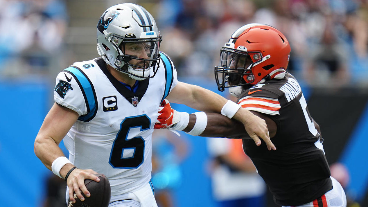 Carolina Panthers quarterback Baker Mayfield looks to pass under pressure from Cleveland Browns lin...